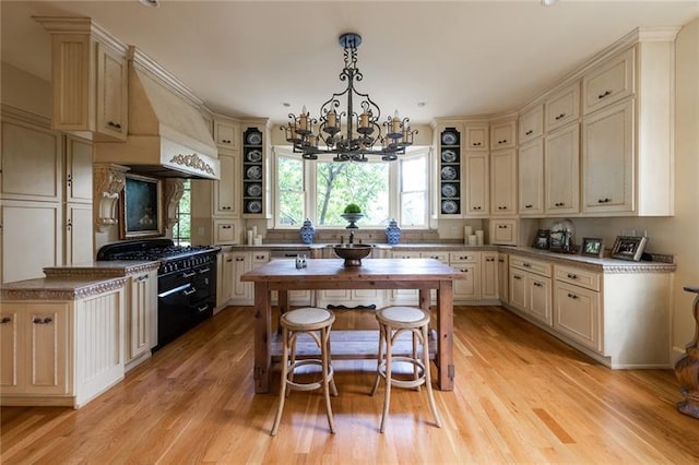 kitchen featuring hanging light fixtures, light wood-type flooring, custom exhaust hood, a chandelier, and cream cabinetry