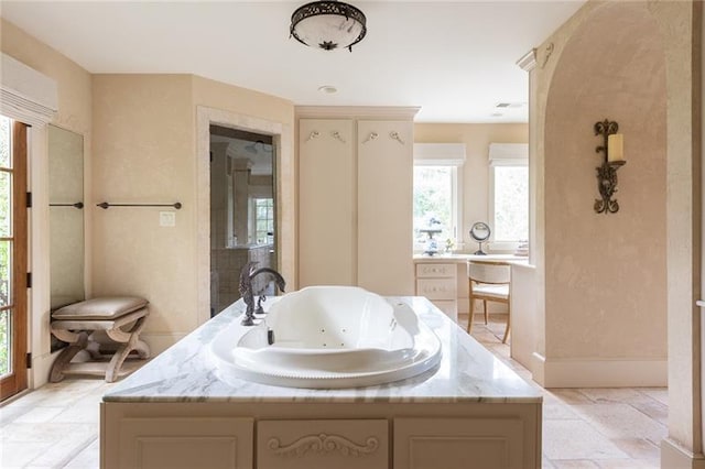 bathroom with vanity, a bath, and tile patterned floors