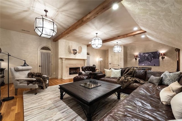 home theater room with a fireplace and light hardwood / wood-style flooring