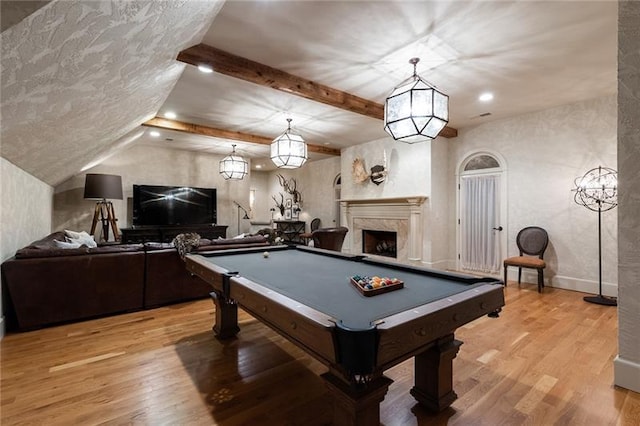 playroom featuring a fireplace, beam ceiling, pool table, and light hardwood / wood-style floors