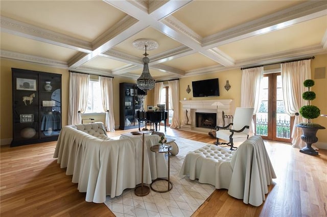 living room with coffered ceiling, light hardwood / wood-style floors, and beam ceiling