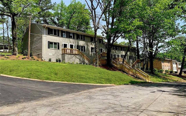 view of front of property with a front yard and stairway