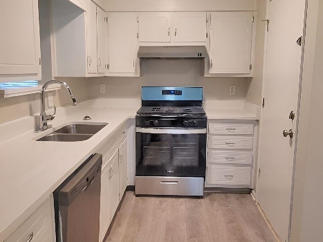 kitchen featuring stainless steel appliances, light hardwood / wood-style floors, white cabinetry, and sink