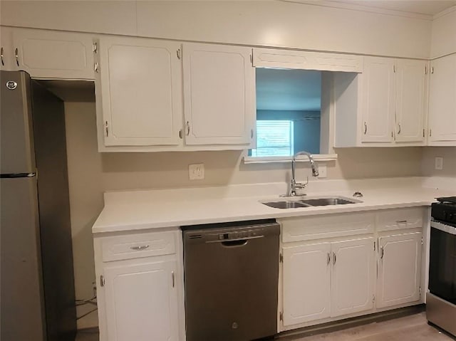 kitchen with sink, white cabinetry, and stainless steel appliances