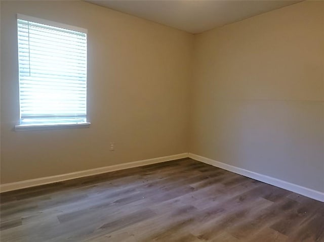 spare room with dark hardwood / wood-style floors