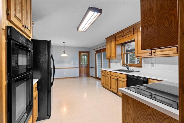 2865 Bryant Ct, Cumming, GA 30040 - kitchen with black appliances, a sink, baseboards, light countertops, and brown cabinets