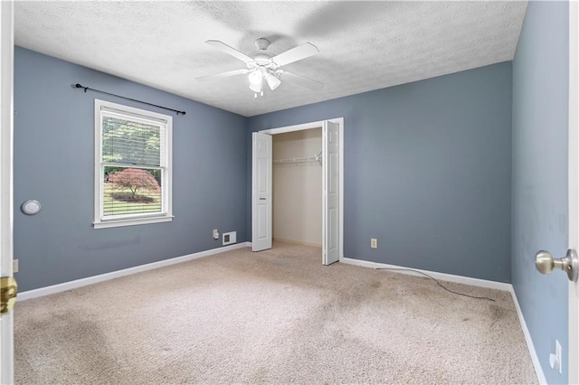 2865 Bryant Ct, Cumming, GA 30040 - unfurnished bedroom featuring carpet, a textured ceiling, baseboards, a closet, and ceiling fan