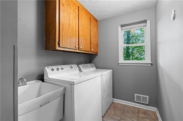 2865 Bryant Ct, Cumming, GA 30040 - washroom with cabinet space, washing machine and clothes dryer, baseboards, and a textured ceiling