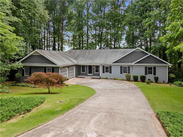 2865 Bryant Ct, Cumming, GA 30040 - single story home with concrete driveway, an attached garage, a front yard, view of wooded area, and a chimney