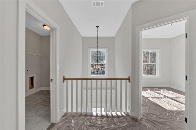 hallway featuring a chandelier