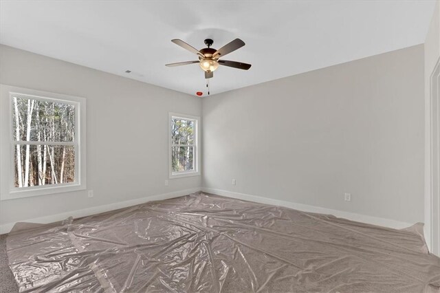 unfurnished room with plenty of natural light and ceiling fan