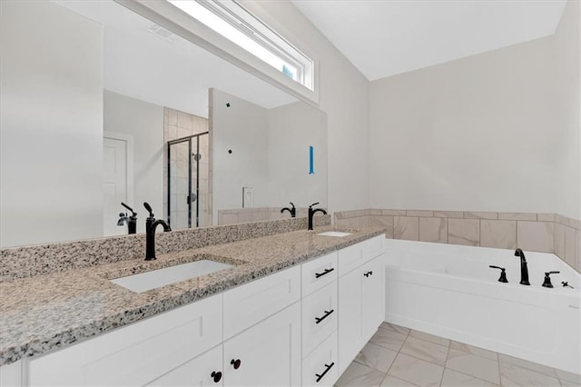 bathroom with vanity and separate shower and tub