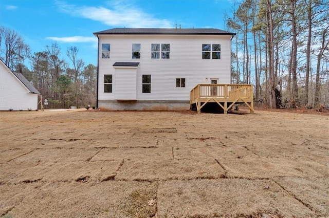 rear view of property featuring a deck