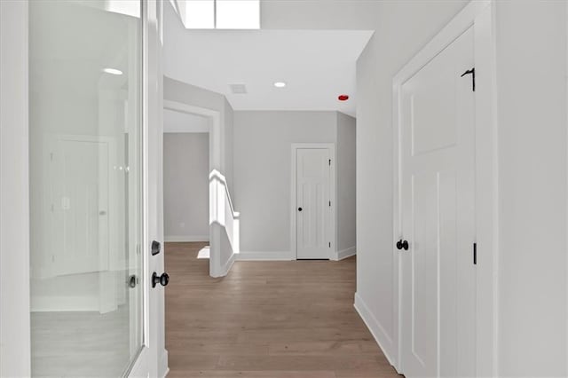 hall with light hardwood / wood-style floors