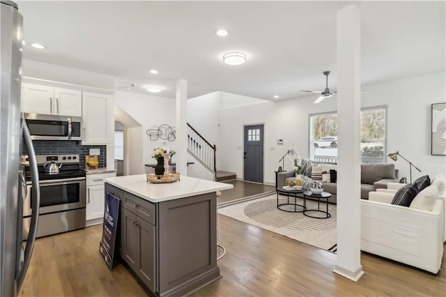 2206 Loring Ct, Decatur, GA 30032 - kitchen with open floor plan, stainless steel appliances, light countertops, and white cabinets