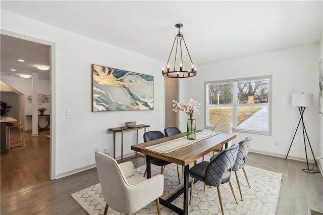 2206 Loring Ct, Decatur, GA 30032 - dining area with wood finished floors, a chandelier, and baseboards