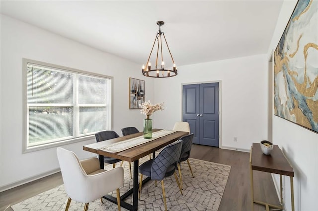 2206 Loring Ct, Decatur, GA 30032 - dining area with wood finished floors, a chandelier, and baseboards