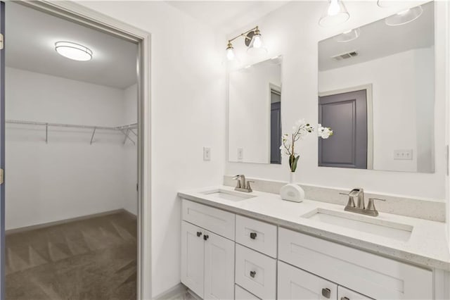 2206 Loring Ct, Decatur, GA 30032 - full bathroom featuring a walk in closet, double vanity, a sink, and visible vents