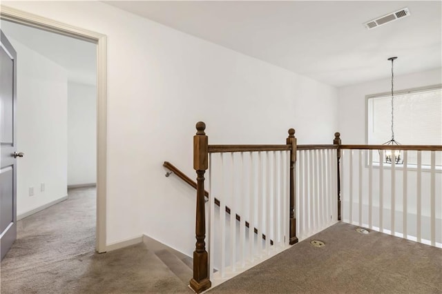 2206 Loring Ct, Decatur, GA 30032 - corridor featuring an upstairs landing, visible vents, baseboards, carpet floors, and a notable chandelier