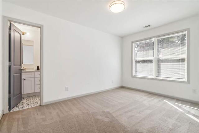 2206 Loring Ct, Decatur, GA 30032 - unfurnished bedroom featuring baseboards, visible vents, ensuite bath, and light colored carpet