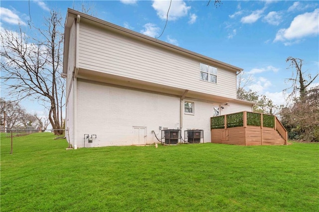 2206 Loring Ct, Decatur, GA 30032 - rear view of house with brick siding, a wooden deck, cooling unit, and a yard