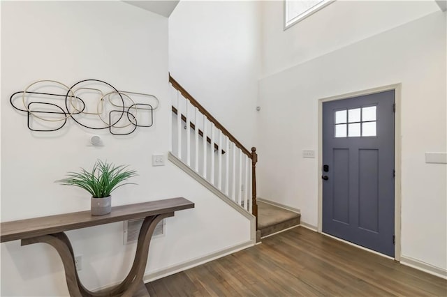 2206 Loring Ct, Decatur, GA 30032 - entrance foyer featuring stairway, visible vents, baseboards, a towering ceiling, and wood finished floors