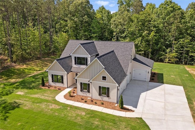 130 W Lake Blvd, Carrollton, GA 30116 - view of front facade with board and batten siding, roof with shingles, driveway, a front yard, and an attached garage