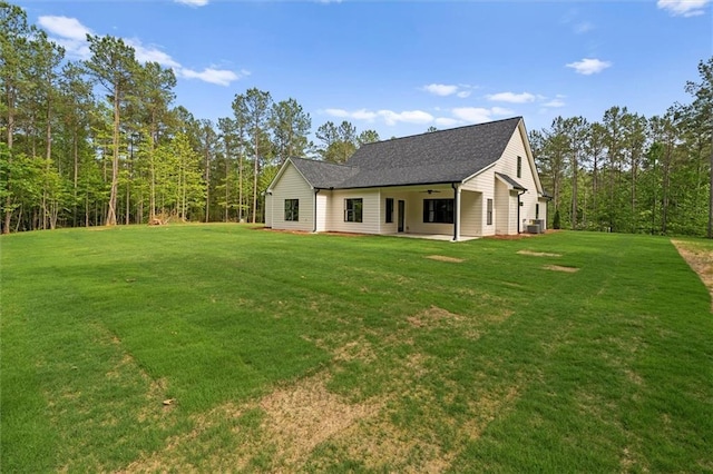 130 W Lake Blvd, Carrollton, GA 30116 - back of house with ceiling fan, a yard, a patio, and roof with shingles