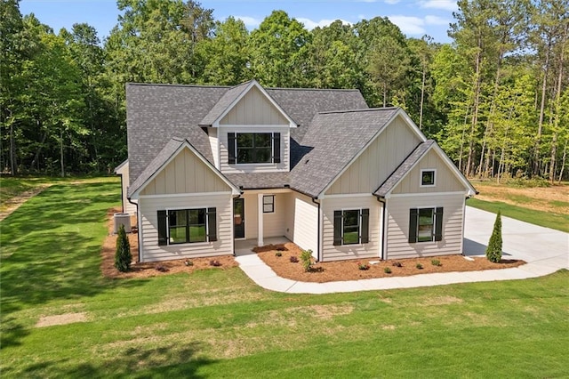 130 W Lake Blvd, Carrollton, GA 30116 - craftsman-style home with a shingled roof, a front yard, central AC, board and batten siding, and concrete driveway