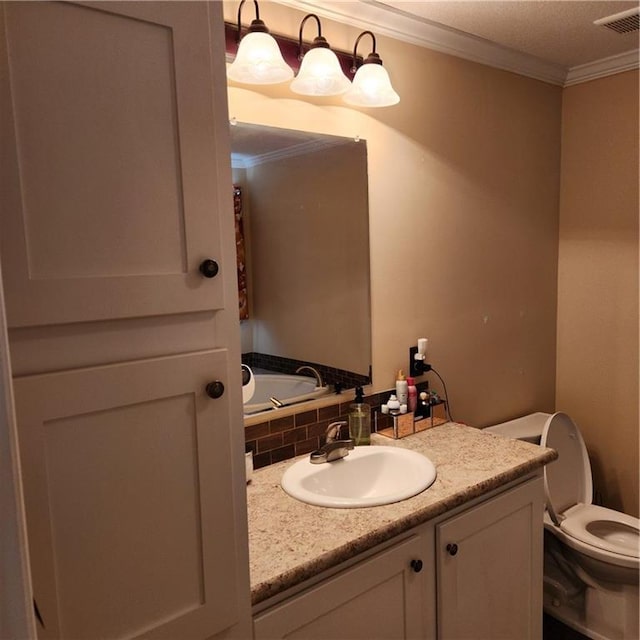 bathroom featuring toilet, visible vents, ornamental molding, and vanity