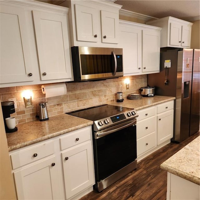 kitchen with white cabinets, stainless steel appliances, tasteful backsplash, and dark wood-type flooring