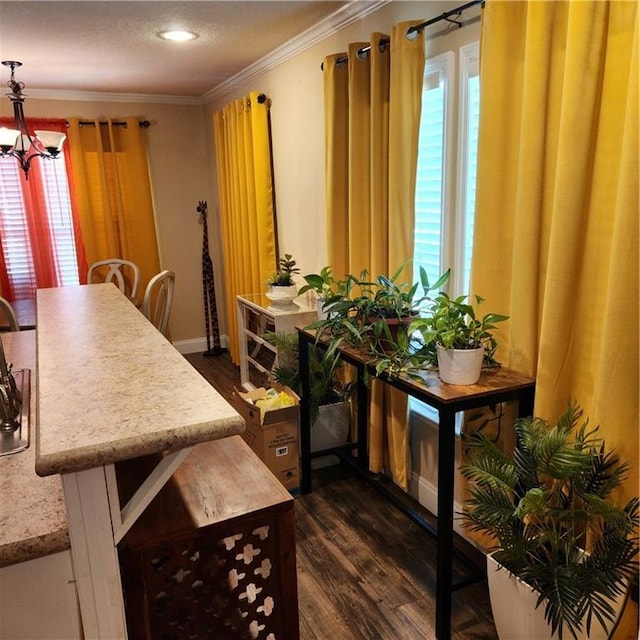 dining area with baseboards, ornamental molding, a chandelier, and dark wood-type flooring