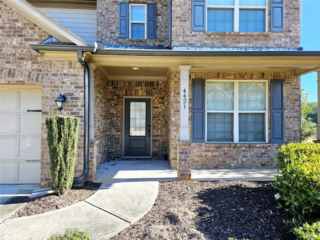 doorway to property with a garage