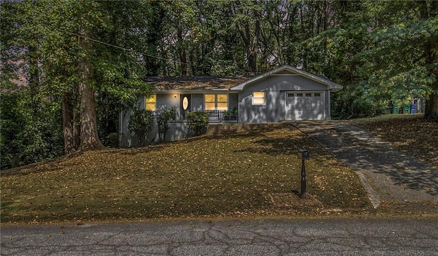 view of front of home with a garage and a front lawn