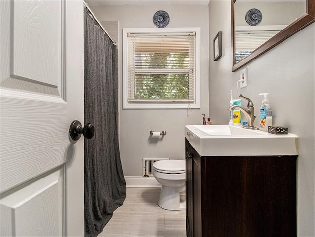 bathroom with curtained shower, wood-type flooring, vanity, and toilet