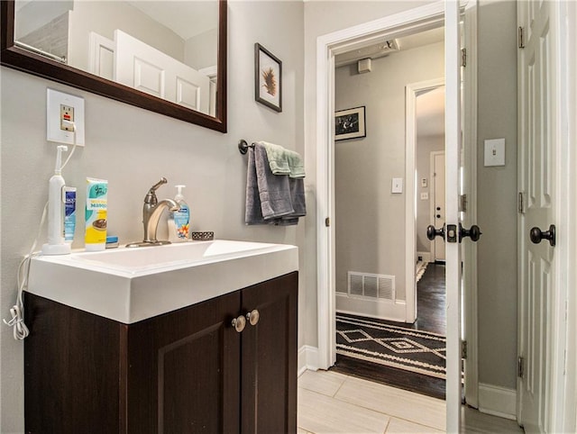 bathroom featuring hardwood / wood-style floors and vanity