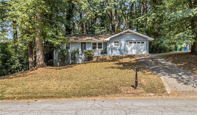 single story home featuring a garage and a front yard