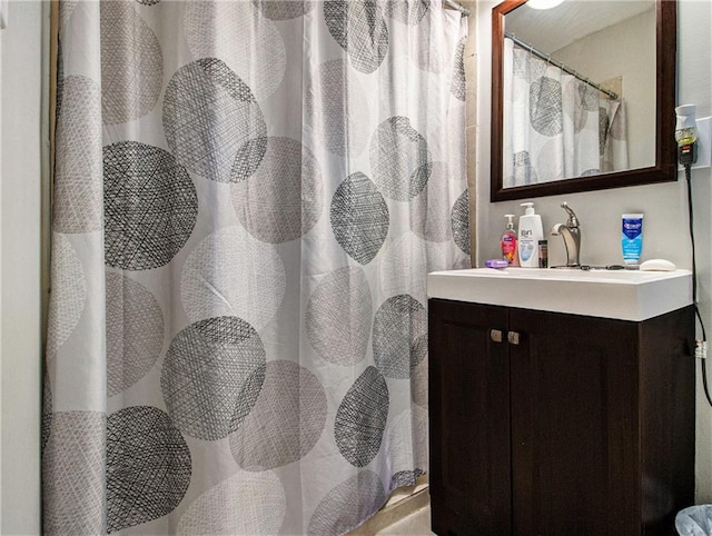 bathroom featuring vanity and a shower with shower curtain