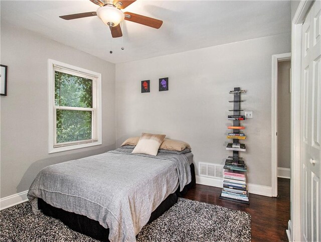 bedroom with a closet, ceiling fan, and dark wood-type flooring