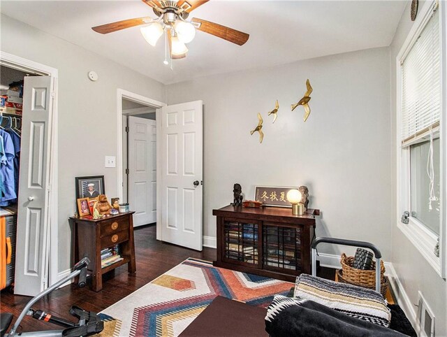 interior space featuring ceiling fan and dark hardwood / wood-style flooring