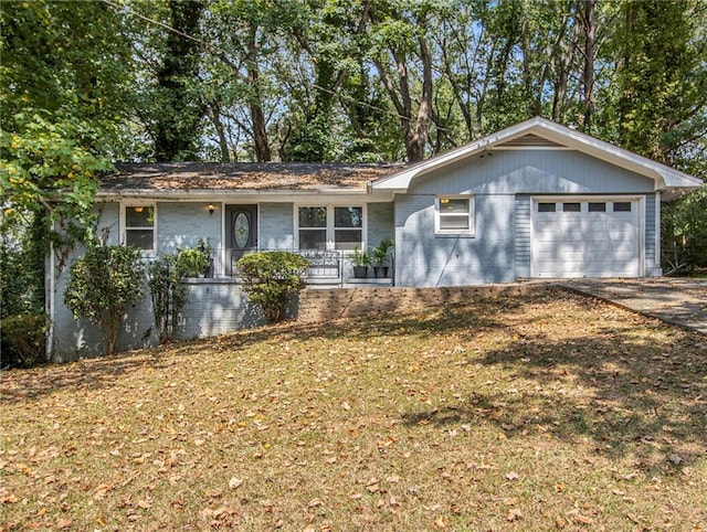 single story home featuring a garage and a front lawn