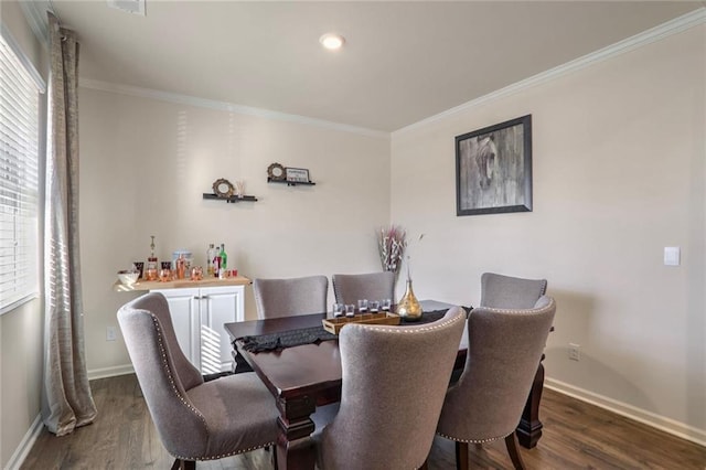 dining area with dark hardwood / wood-style flooring and ornamental molding