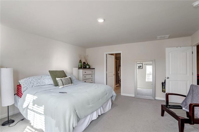 carpeted bedroom featuring ensuite bathroom