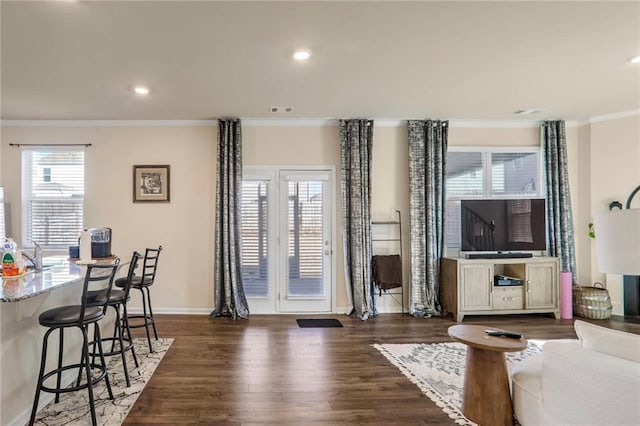 living room featuring dark wood-type flooring and crown molding