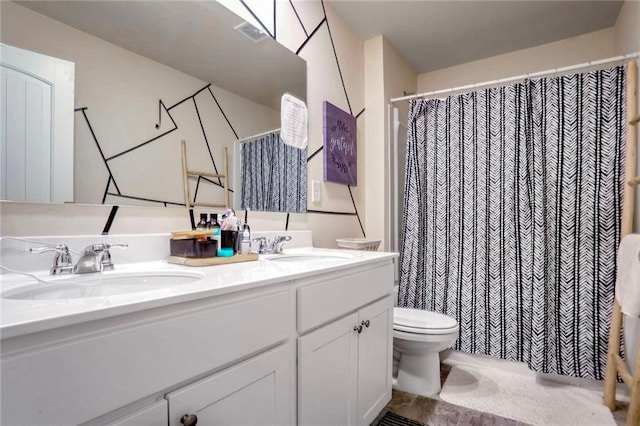 bathroom featuring toilet and vanity