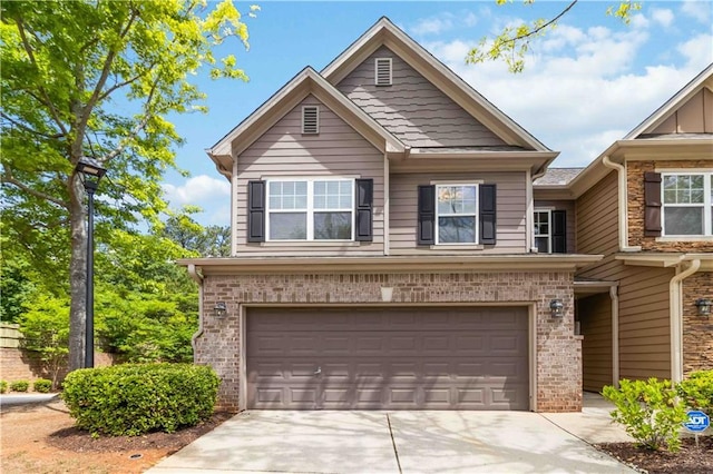 view of front of property with a garage, concrete driveway, and brick siding