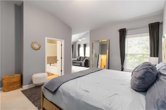 carpeted bedroom with lofted ceiling and ensuite bathroom