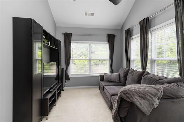 living area with vaulted ceiling, light colored carpet, and baseboards