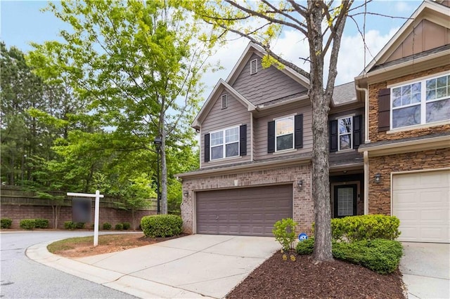 view of front of property featuring an attached garage, fence, and concrete driveway