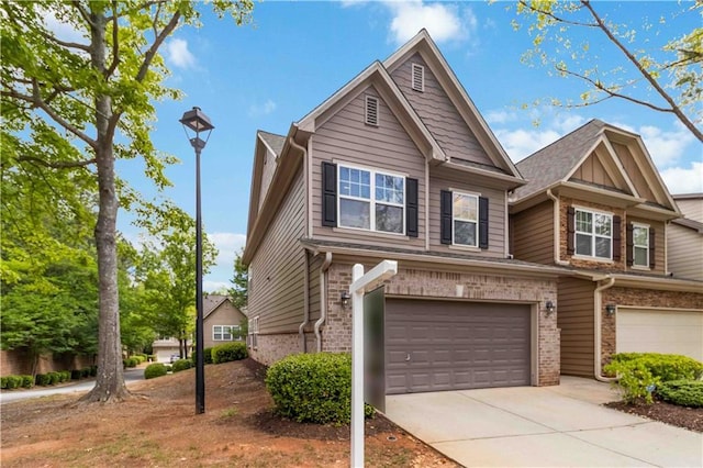 view of front of property featuring brick siding, an attached garage, and concrete driveway